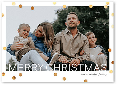 A modern Christmas card with festive gold polka dots and family photo