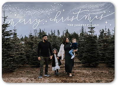 A photo Christmas card with the words Merry Christmas and some decorative, snowy accents