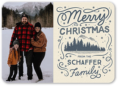 A photo family Christmas card with handwritten script saying Merry Christmas