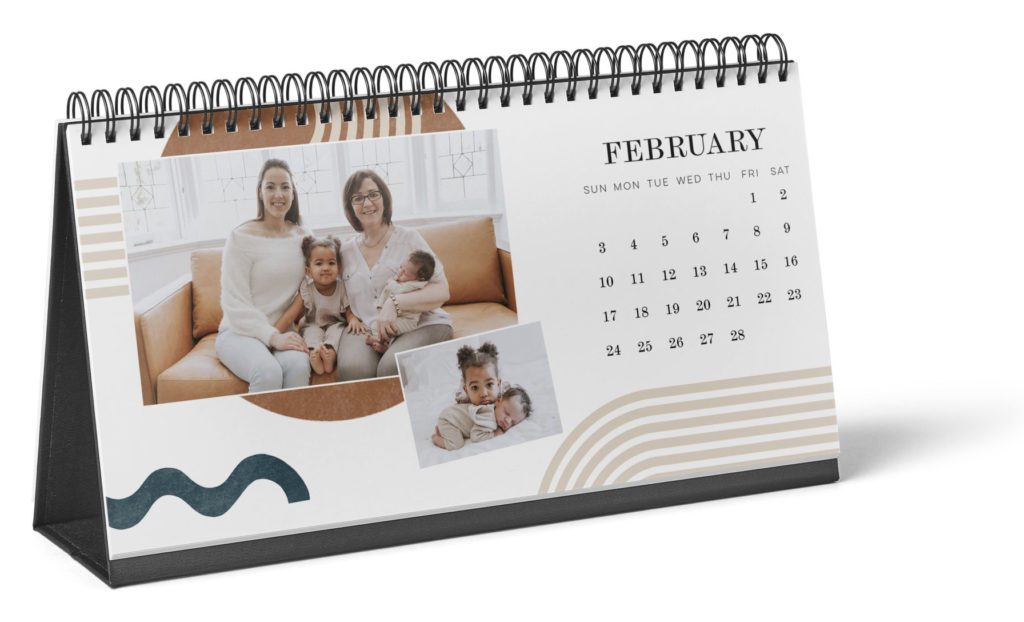 Desk calendar with the page turned to february with two pictures on the left side