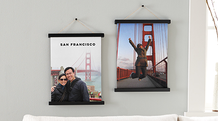 Two hanging canvas prints of a couple posing in front of the Golden Gate Bridge in San Francisco 